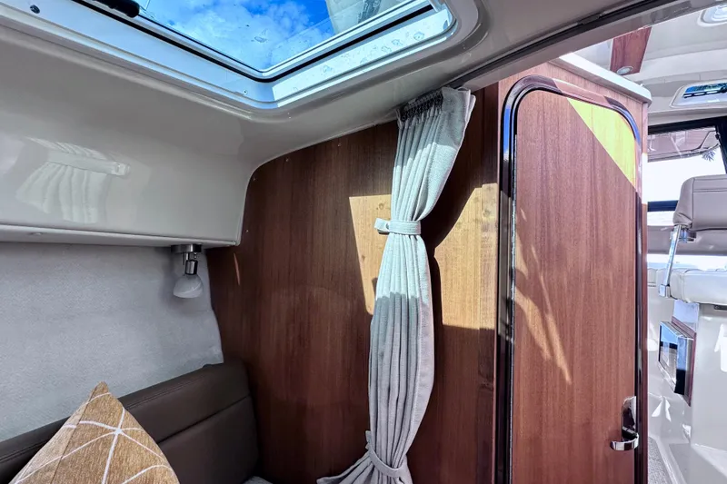 Slide: The Image of Interior of 2026 Ranger Tugs R-25 boat with wood paneling and skylight. - 27