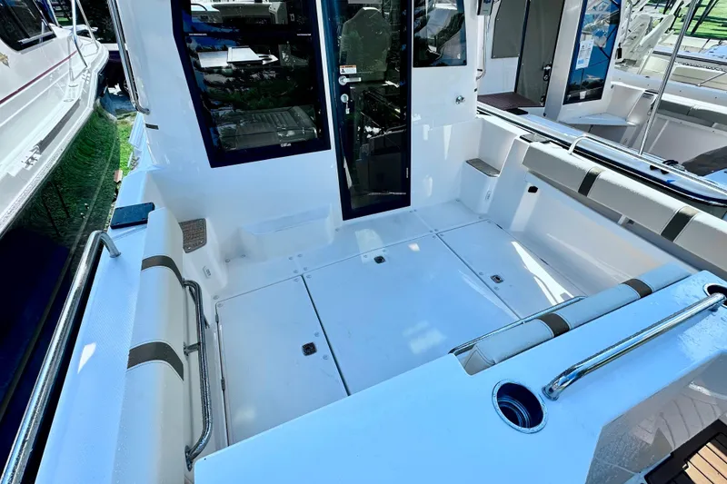 Slide: The Image of 2026 Ranger Tugs R-25 boat cockpit with seating and storage compartments. - 36