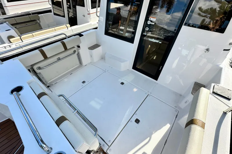 Slide: The Image of 2026 Ranger Tugs R-25 boat interior with seating and storage compartments. - 38