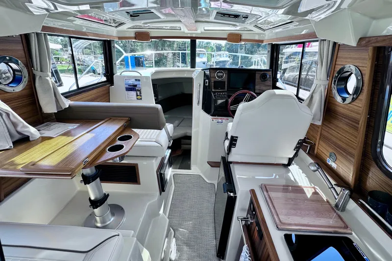 Slide: The Image of Interior of 2026 Ranger Tugs R-25 boat, featuring modern design and wood accents. - 6
