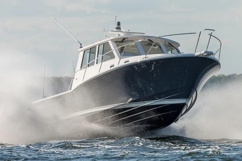 Slide: The Image of Triple Yamaha outboard engines on a NorthCoast 415 HT, 2026 model, docked on a wooden pier. - 3