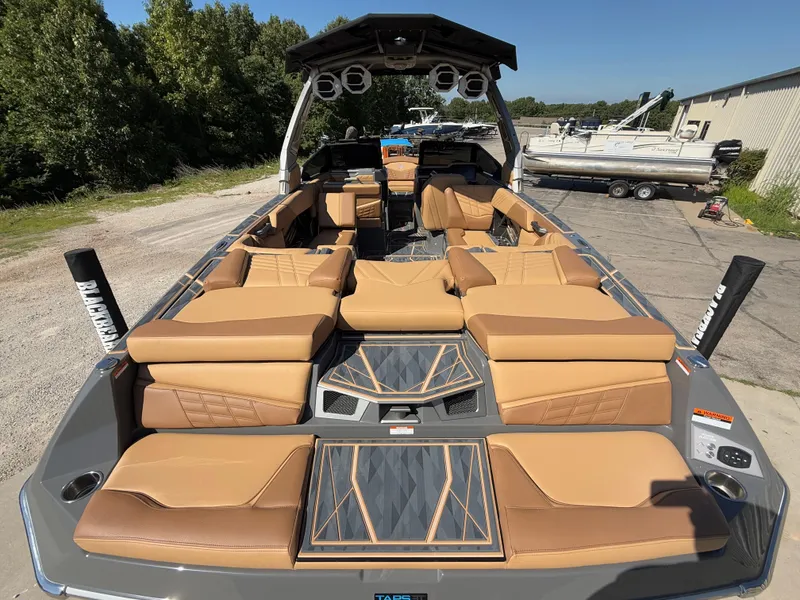 Slide: The Image of 2025 Tigé Ultré 25ZX boat interior with luxurious tan seating and modern design. - 6