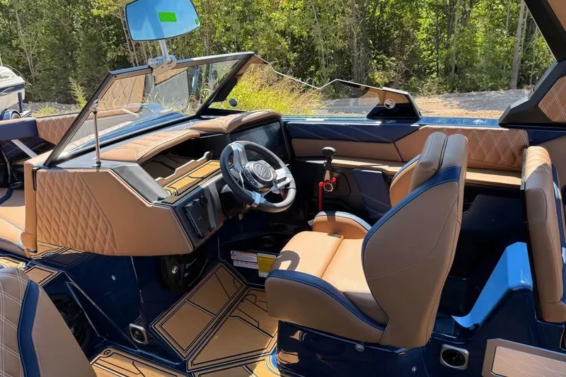 Slide: The Image of 2026 Tigé 24RZX boat interior with luxurious tan and blue seating, modern dashboard. - 11