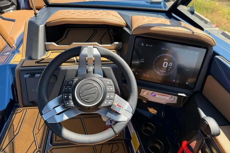 Slide: The Image of 2026 Tigé 24RZX boat dashboard with modern steering wheel and digital display. - 12