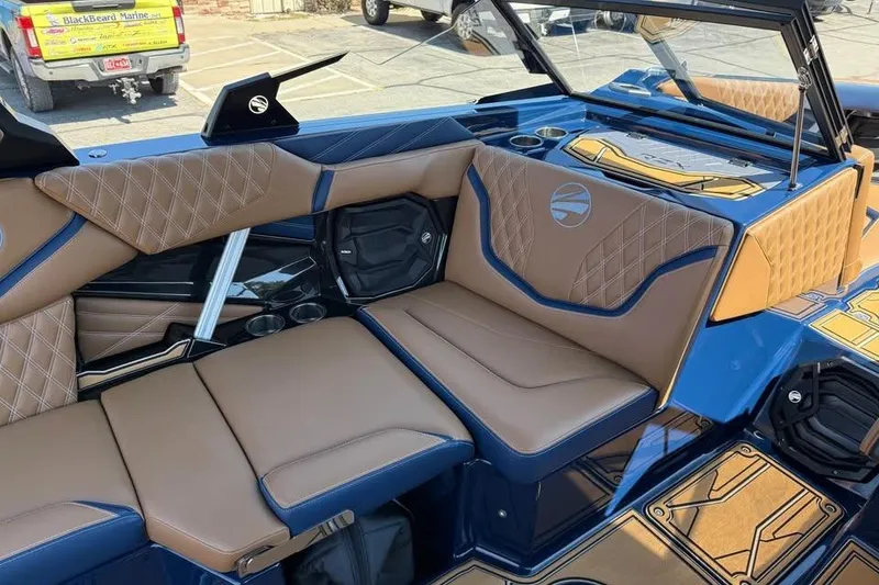 Slide: The Image of 2026 Tigé 24RZX boat interior with luxurious brown and blue seating, diamond stitching. - 13