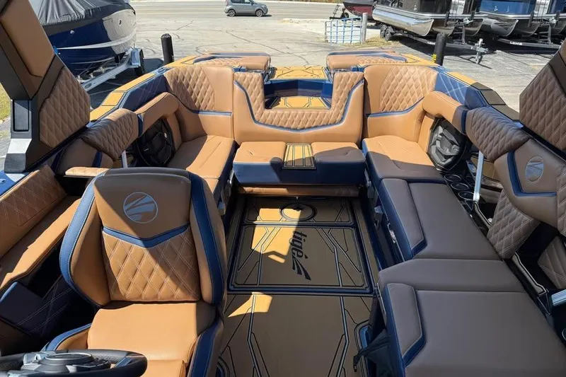 Slide: The Image of Luxurious interior of 2026 Tigé 24RZX boat with tan and blue seating. - 16
