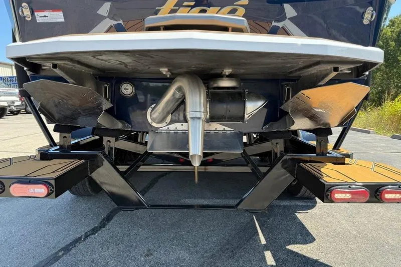 Slide: The Image of Rear view of 2026 Tigé 24RZX boat showcasing exhaust and wakeboard features. - 5
