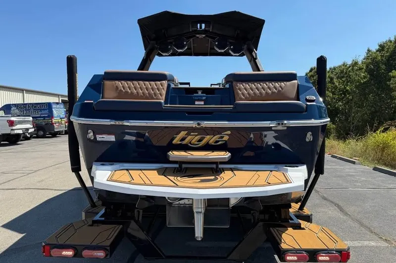 Slide: The Image of 2026 Tigé 24RZX boat rear view with teak deck and sleek design. - 6