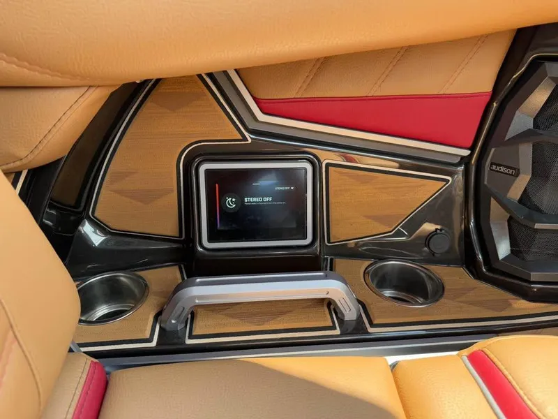 Slide: The Image of 2024 Tigé Ultré 25ZX interior with touchscreen and cup holders. - 18
