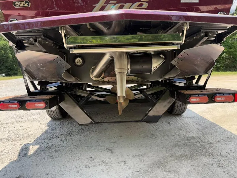 Slide: The Image of Rear view of 2024 Tigé Ultré 25ZX boat, showcasing propeller and exhaust system. - 5