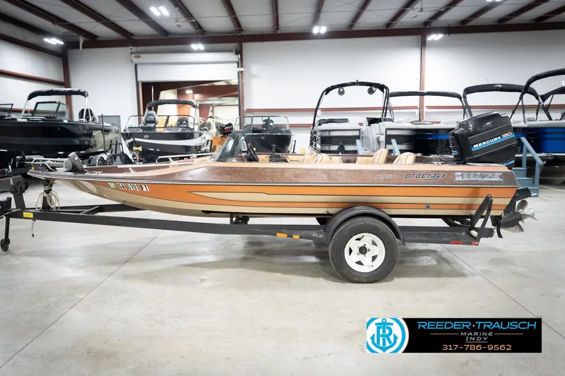 Slide: The Image of 1986 ProCraft 1775 Bass boat on trailer in indoor showroom. - 10