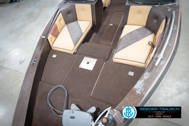 Slide: The Image of 1986 ProCraft 1775 Bass boat interior with brown and tan seating, Reeder-Trausch Marine logo. - 11