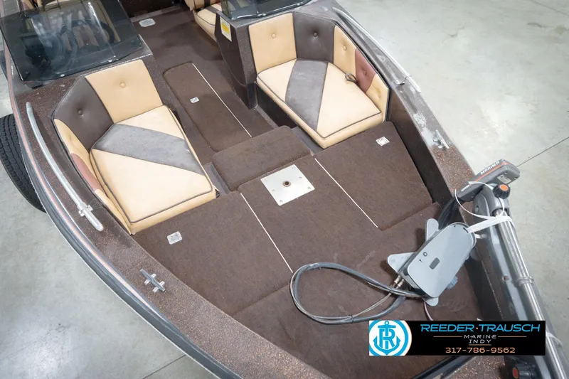 Slide: The Image of 1986 ProCraft 1775 Bass boat interior with tan and brown seating, trolling motor, and carpeted deck. - 12