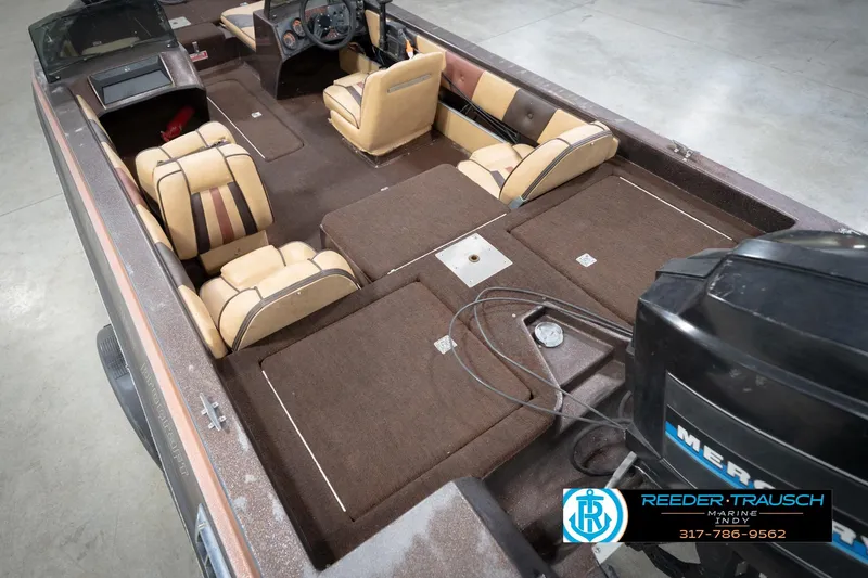 Slide: The Image of 1986 ProCraft 1775 Bass boat interior with tan and brown seating, showcased by Reeder-Trausch Marine. - 14