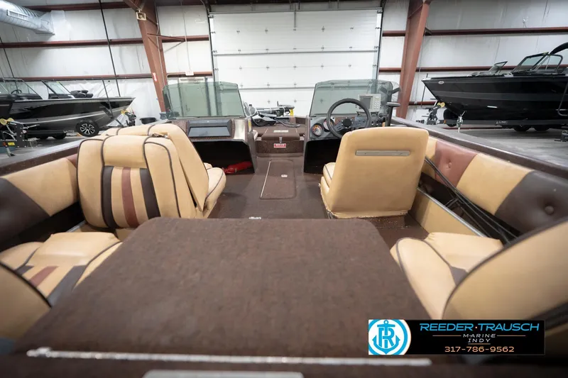 Slide: The Image of 1986 ProCraft 1775 Bass boat interior with tan and brown seating in a showroom. - 15