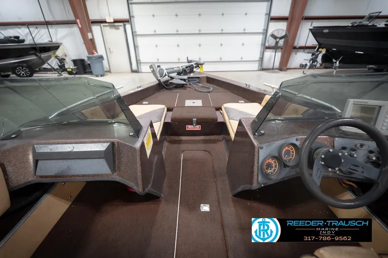 Slide: The Image of 1986 ProCraft 1775 Bass boat interior with steering wheel and dashboard in a showroom. - 16