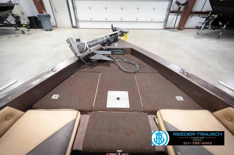 Slide: The Image of 1986 ProCraft 1775 Bass boat interior with trolling motor in a garage setting. - 17