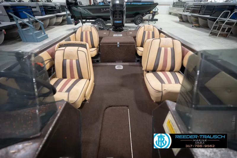 Slide: The Image of 1986 ProCraft 1775 Bass boat interior with striped seats in a showroom. - 19