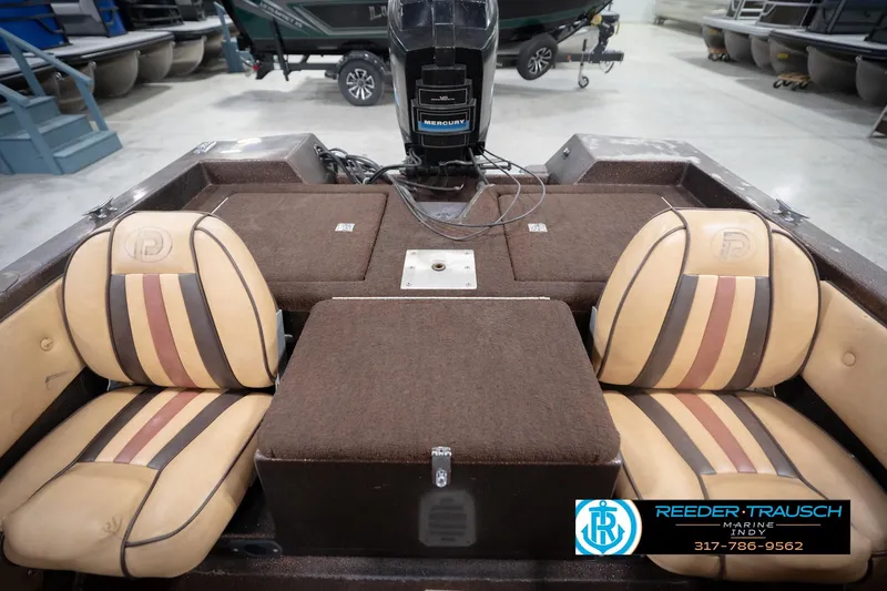 Slide: The Image of 1986 ProCraft 1775 Bass boat interior with tan and brown seating, Mercury engine visible. - 20