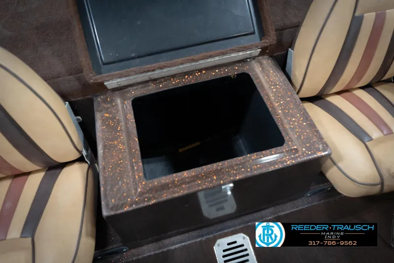 Slide: The Image of 1986 ProCraft 1775 Bass boat interior with storage compartment and striped seats. - 22