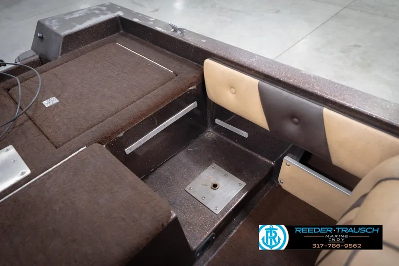 Slide: The Image of 1986 ProCraft 1775 Bass boat interior with brown upholstery and seating area. - 25