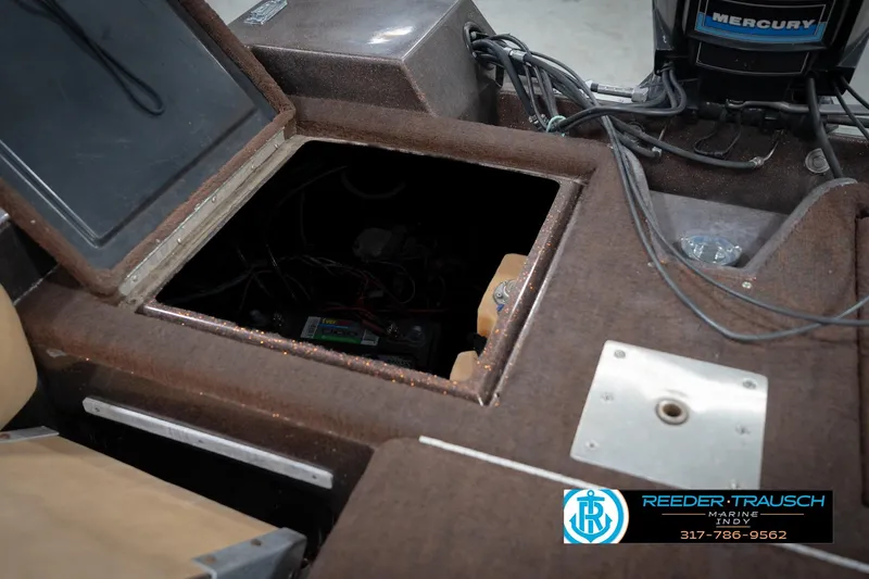 Slide: The Image of 1986 ProCraft 1775 Bass boat interior with open compartment and visible wiring. - 27