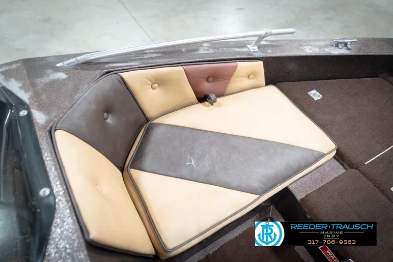 Slide: The Image of 1986 ProCraft 1775 Bass boat interior with cushioned seating and Reeder-Trausch Marine logo. - 32