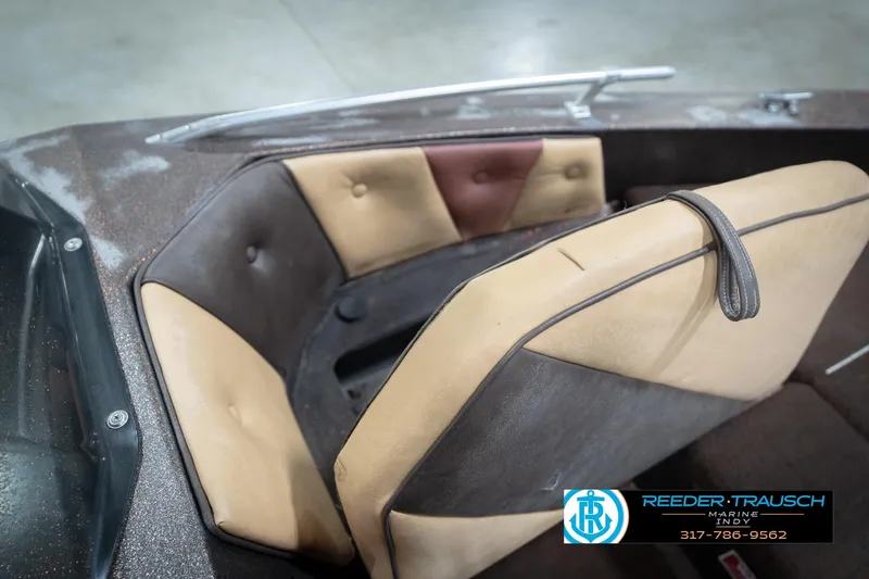 Slide: The Image of 1986 ProCraft 1775 Bass boat interior with tan and brown seating, Reeder-Trausch Marine logo. - 33