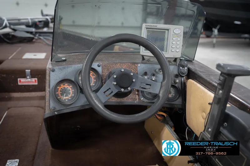 Slide: The Image of 1986 ProCraft 1775 Bass boat dashboard with steering wheel and gauges. - 35