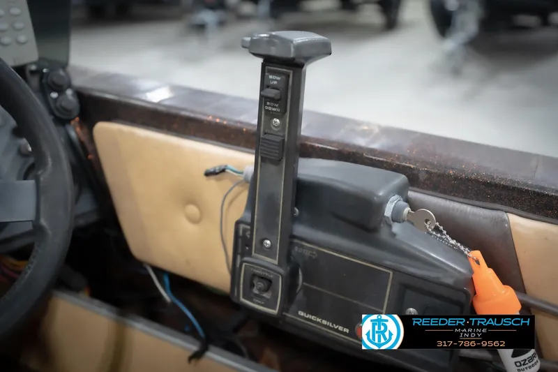 Slide: The Image of 1986 ProCraft 1775 Bass boat control panel with throttle and steering wheel. - 44