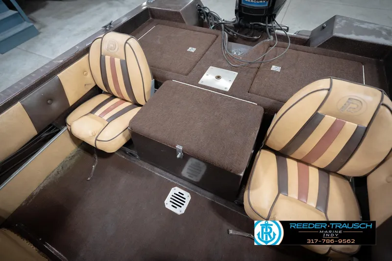 Slide: The Image of 1986 ProCraft 1775 Bass boat interior with striped seats and storage compartments. - 47