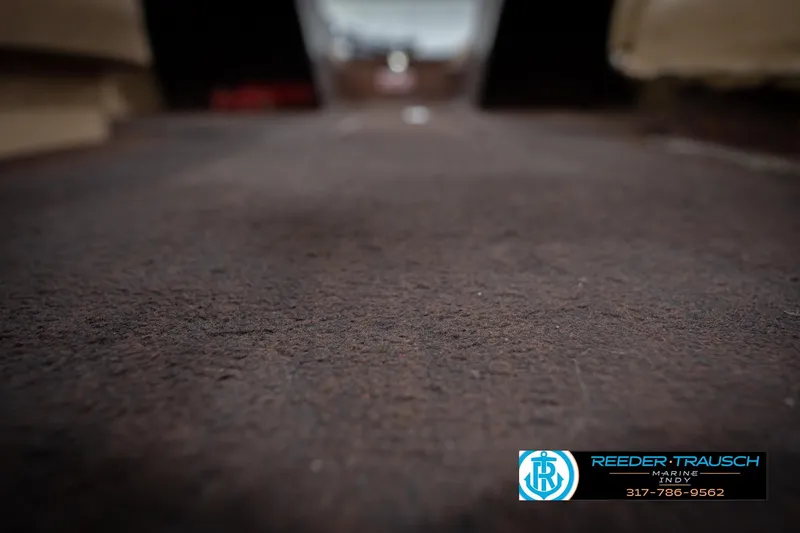 Slide: The Image of 1986 ProCraft 1775 Bass boat interior with carpeted flooring, Reeder Trausch Marine logo. - 49