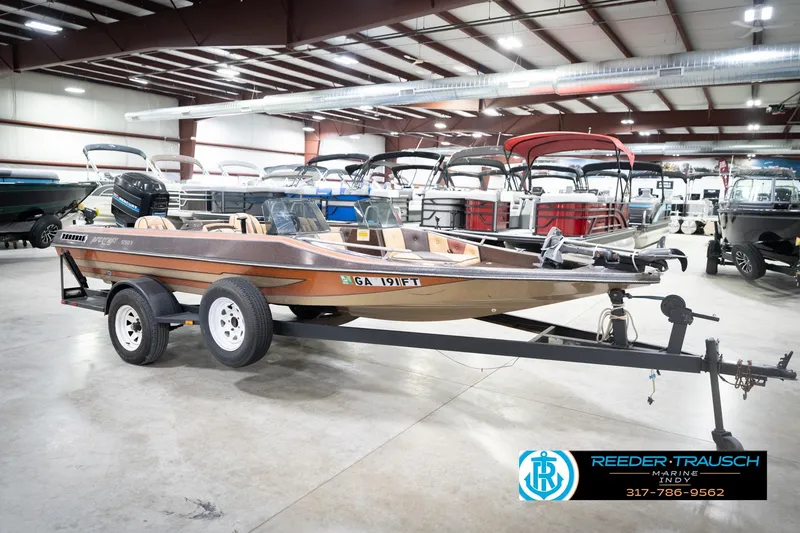 Slide: The Image of 1986 ProCraft 1775 Bass boat on trailer in indoor showroom. - 5