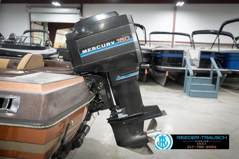 Slide: The Image of 1986 ProCraft 1775 Bass boat with Mercury 150 outboard motor in showroom. - 50
