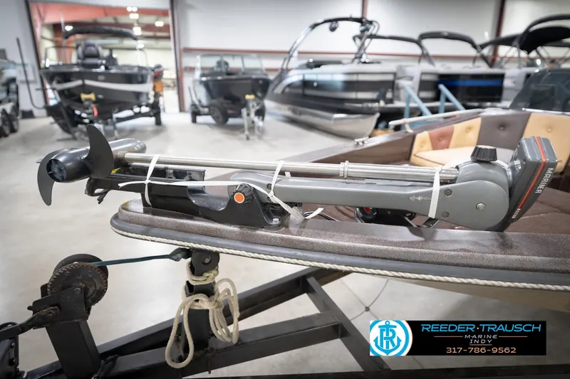 Slide: The Image of 1986 ProCraft 1775 Bass boat with trolling motor in showroom, Reeder-Trausch Marine logo visible. - 54