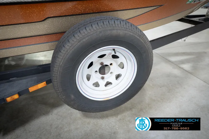 Slide: The Image of 1986 ProCraft 1775 Bass boat trailer tire on display in a showroom. - 60