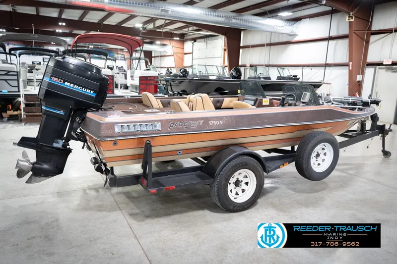 Slide: The Image of 1986 ProCraft 1775 Bass boat with Mercury 150 engine on trailer in showroom. - 7