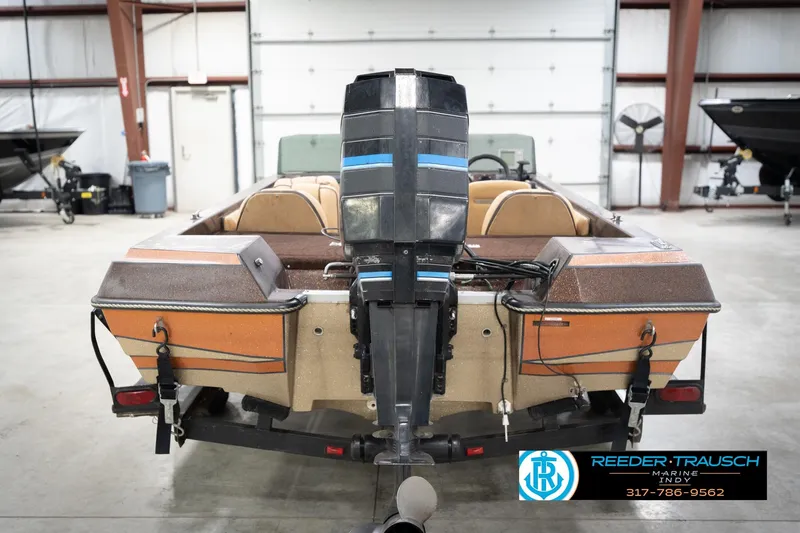 Slide: The Image of 1986 ProCraft 1775 Bass boat in a garage, rear view with motor. - 8