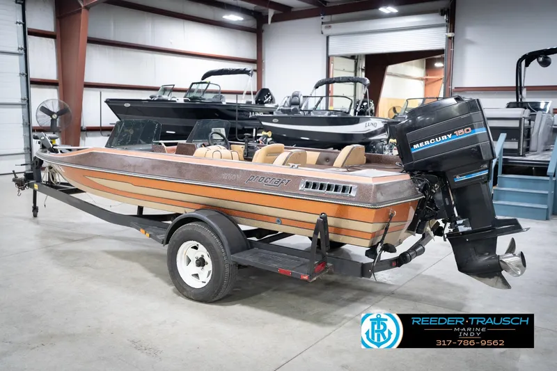 Slide: The Image of 1986 ProCraft 1775 Bass boat with Mercury 150 engine in showroom. - 9