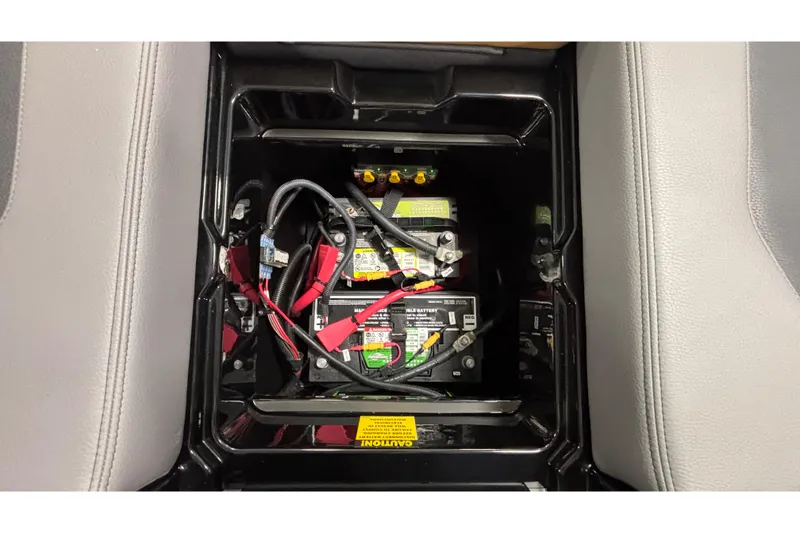 Slide: The Image of Battery compartment of 2026 Tigé Ultré 25ZX boat, featuring wiring and connections. - 18