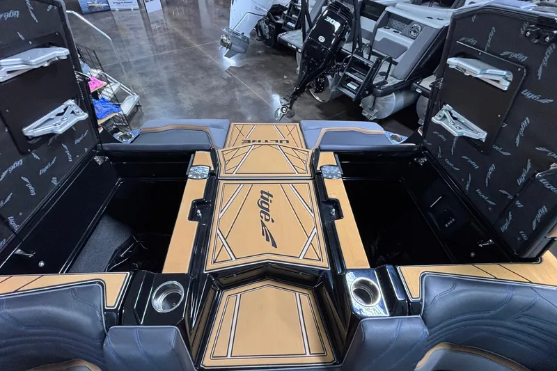 Slide: The Image of 2026 Tigé Ultré 25ZX boat interior with open storage compartments and sleek design. - 25
