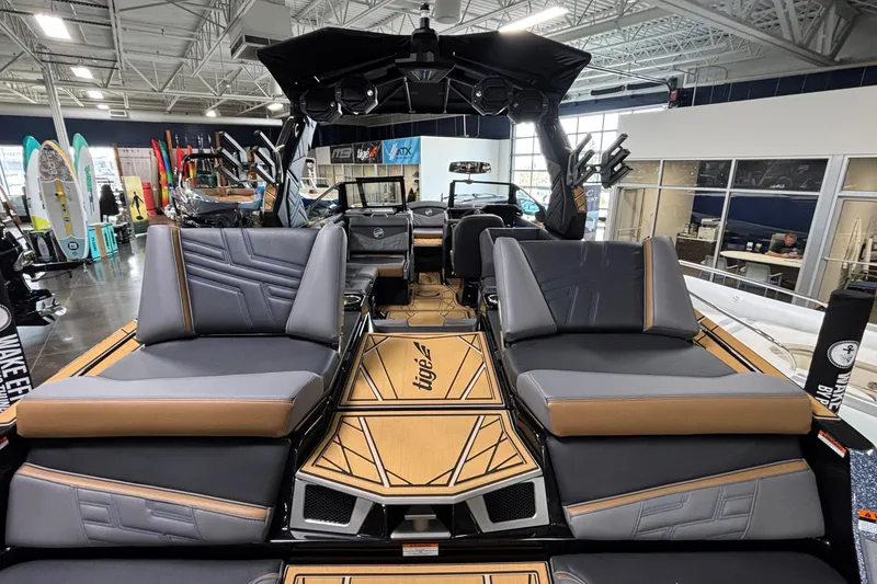Slide: The Image of 2026 Tigé Ultré 25ZX boat interior with luxurious seating and modern design in showroom. - 32