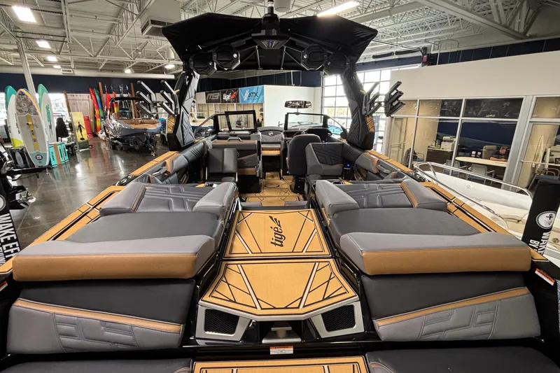 Slide: The Image of 2026 Tigé Ultré 25ZX boat interior with luxurious seating and modern design in showroom. - 6