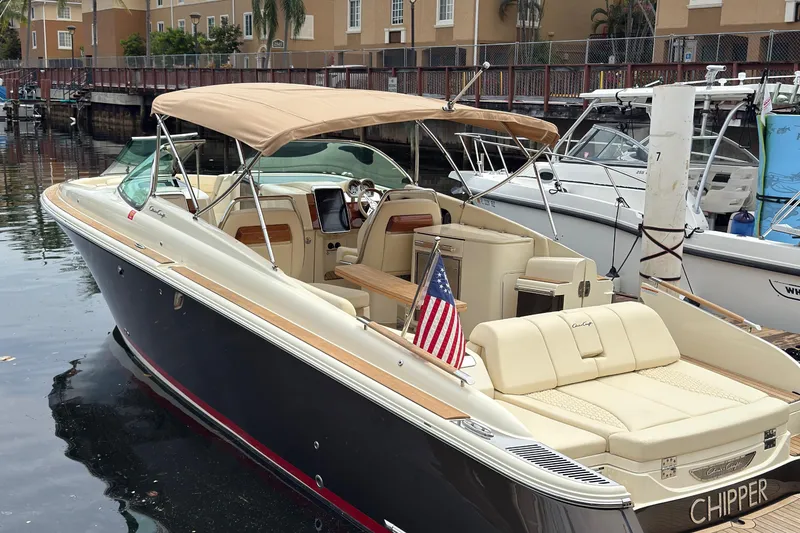 The Image of 2022 Chris-Craft Launch 35 GT boat docked, featuring elegant design and American flag. - 1