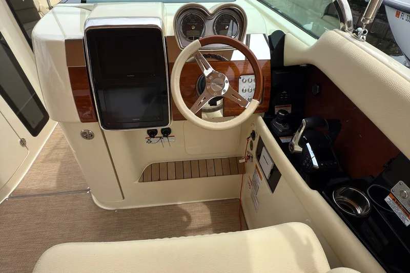 Slide: The Image of 2022 Chris-Craft Launch 35 GT helm with wood accents and modern controls. - 13