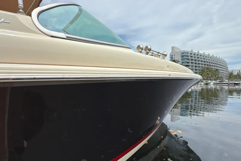 Slide: The Image of 2022 Chris-Craft Launch 35 GT boat docked near modern waterfront buildings. - 4
