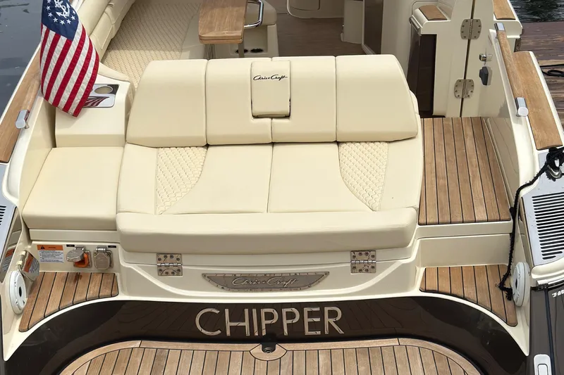 Slide: The Image of 2022 Chris-Craft Launch 35 GT boat with beige seating and American flag. - 6