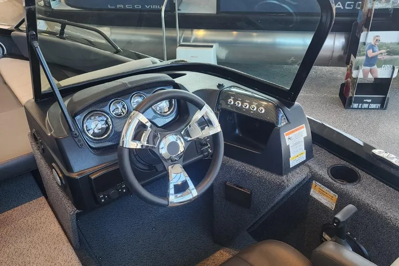 Slide: The Image of Steering console of a 2023 Lowe boat with modern gauges and controls. - 12