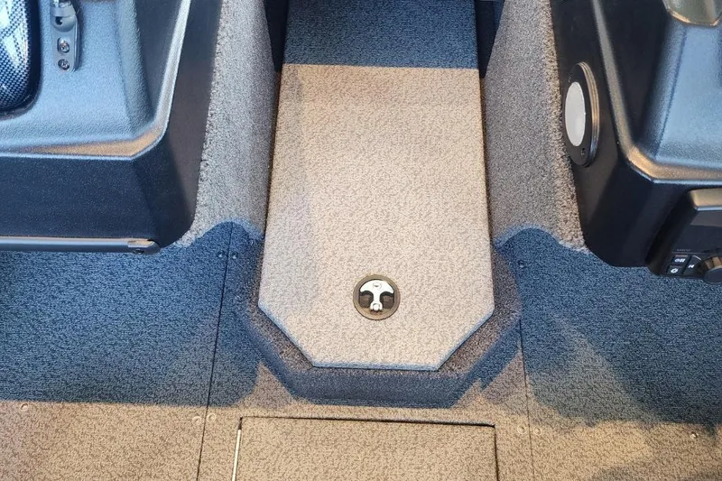 Slide: The Image of Interior of a 2023 Lowe boat, featuring carpeted flooring and storage compartments. - 14