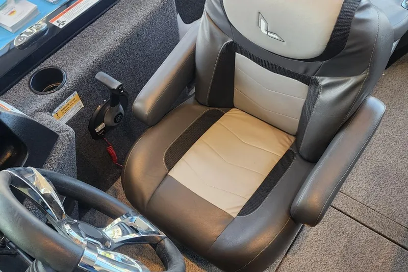 Slide: The Image of 2023 Lowe boat captain's seat with steering wheel and control panel. - 22